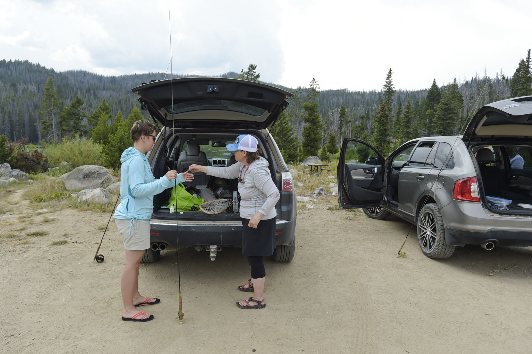 Jennifer Davis, left, and Shalon Hastings rig up their rods